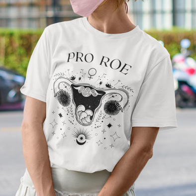 white shirt says pro roe with celestial uterus design