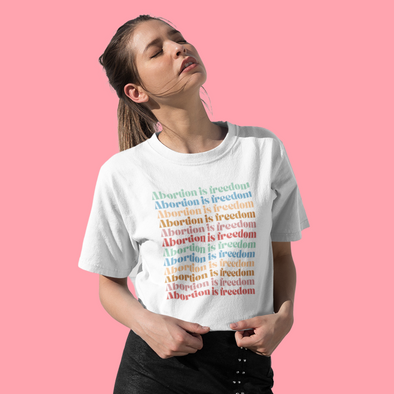 white shirt that says abortion is freedom in pastel gradient