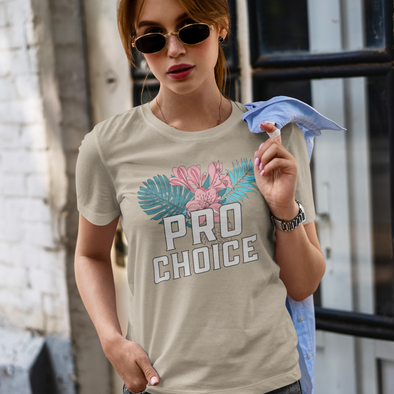 woman wearing sunglasses and a shirt with tropical flowers that says pro choice